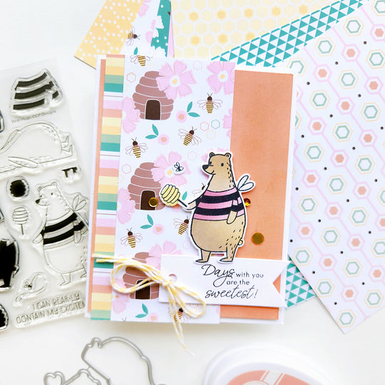 “Days with you are the sweetest” card featuring a bear, set on floral and beehive paper with bees and a stripe accent.