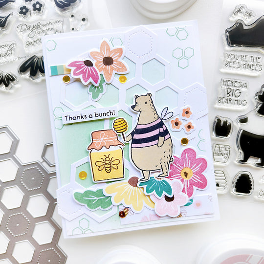 “Thanks a bunch” card featuring a bear beside a honey jar, accented with floral, sequin and honeycomb background.