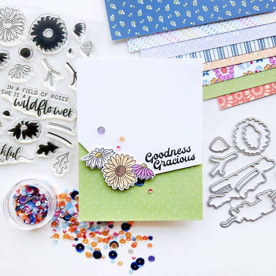 A card with the sentiment "Goodness Gracious," featuring a daisy accent, set against green polka dot patterned paper and sequin.