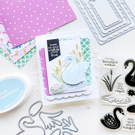 "Hope all your wishes come true" card featuring a swan on a rippled pond with cattails, a lily pad, set on floral and abstract-patterned paper.