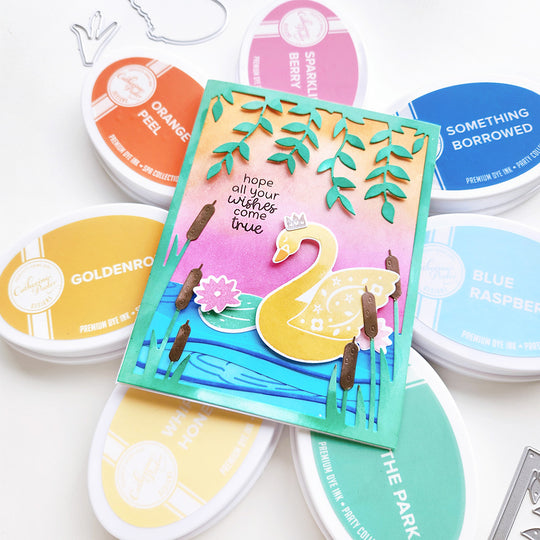 "May all your wishes come true" card with a swan on a pond, cattails, a lily pad, cascading vines, and a soft ink-blended background.