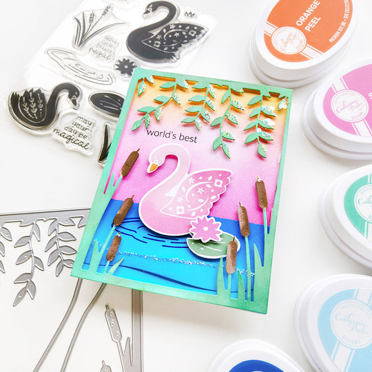 "World's best Mom" sentiment card featuring a pink swan on a rippled lake background, surrounded by hanging vines.