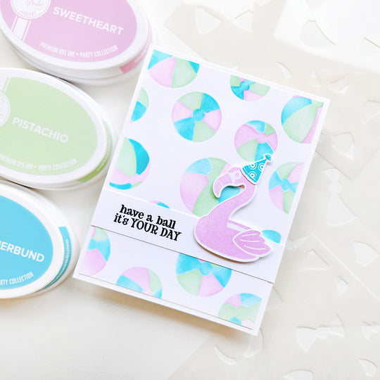 "Have a ball it's your day" card featuring a  flamingo set on colorful beach balls.