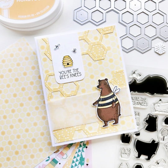 “You’re the bee's knees” card with a bear, accented with honeycomb patterned paper and bees buzzing around hive.