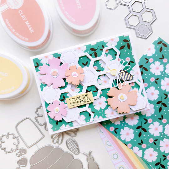 "You're the Bee's Kness" card featuring a bee, flowers and honeycomb shapes atop floral-patterned paper.