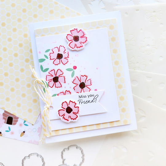 "Miss you friend" card with a flowers  on top of honeycomb shaped paper.