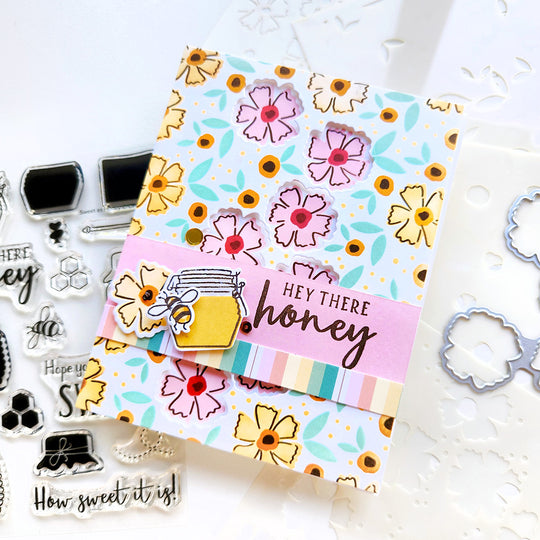 "Hey there honey" card with a honey pot and bee set on a floral background and a sequin accent.