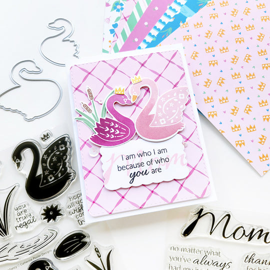 "Mom, I am who I am because of you" card featuring two swans and cattails on pink ribbon-patterned paper.
