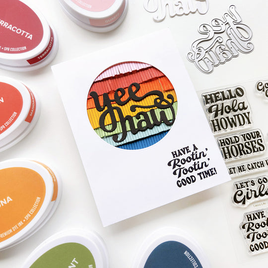 A card with "Yeehaw, have a rootin' tootin' good time" sentiment, featuring a vibrant circle of rainbow fringe for a colorful western vibe!