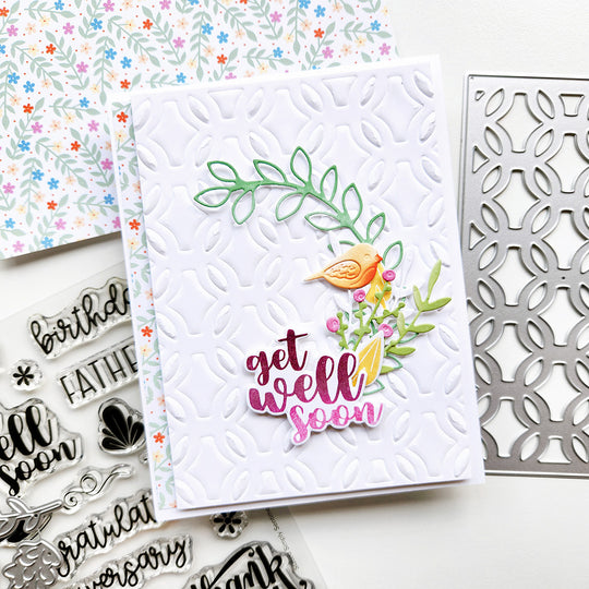 Handmade card with 'get well soon' text and decorative elements on a white background.