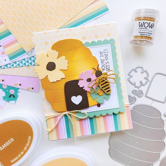 "You're the bee’s knees" card with a beehive, surrounded by flowers and a bee, accented by circle and striped paper.