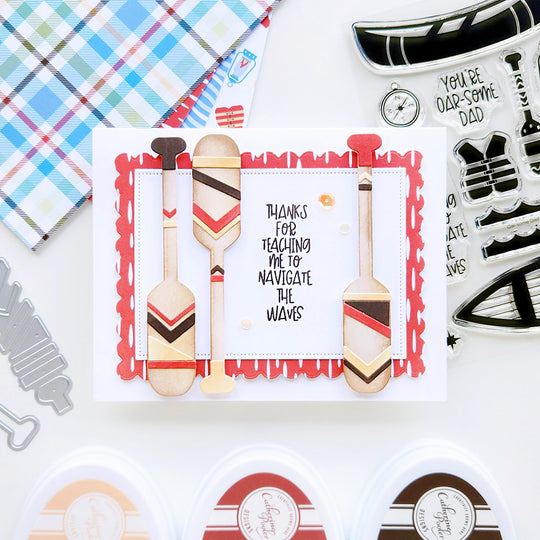 “Thanks for teaching me to navigate the waves,” accented by decorative paddles and whimsical patterned paper.
