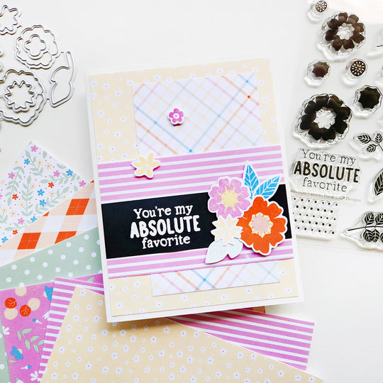 Handmade card with decorative flowers and patterned pape.