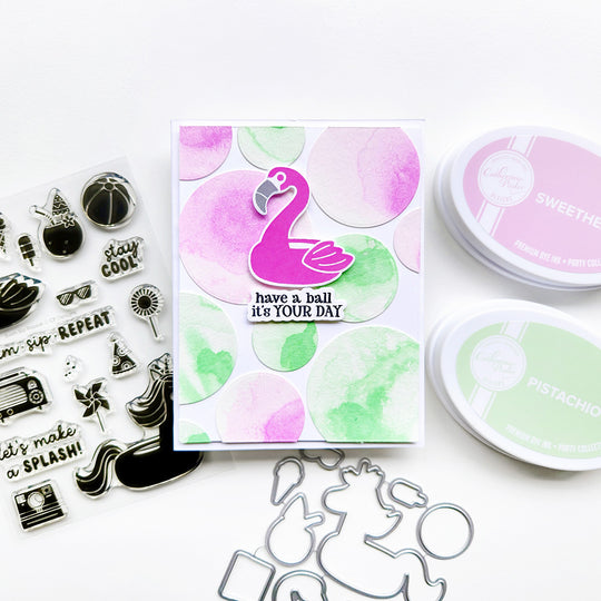 "Have a ball it's your day" card featuring a flamingo set on top of watercolor circles.