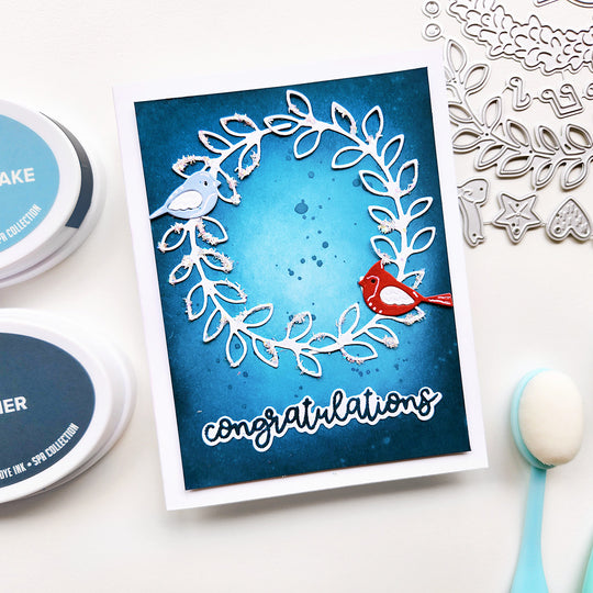 Handmade card with 'congratulations' text and decorative elements on a white background