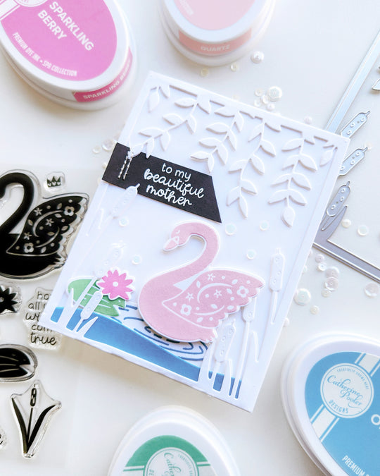 "To my beautiful mother" card with a pink swan on a rippled pond with cattails, lily pad, hanging vines, and pearl sequin accents.