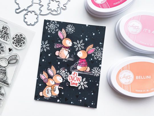 Skiing Bunnies with snow on a black card