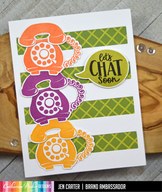 Orange, purple, and yellow rotary phones with speech bubble on green and white background