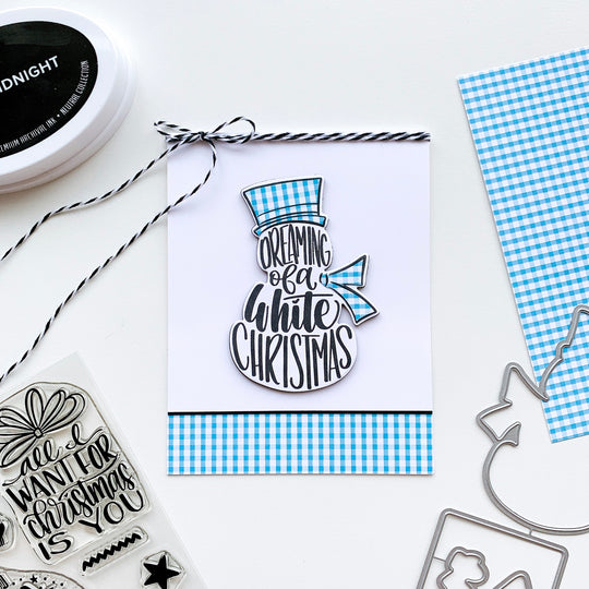 Snowman with plaid hat and scarf on blue and white plaid border and cookies and cream twine