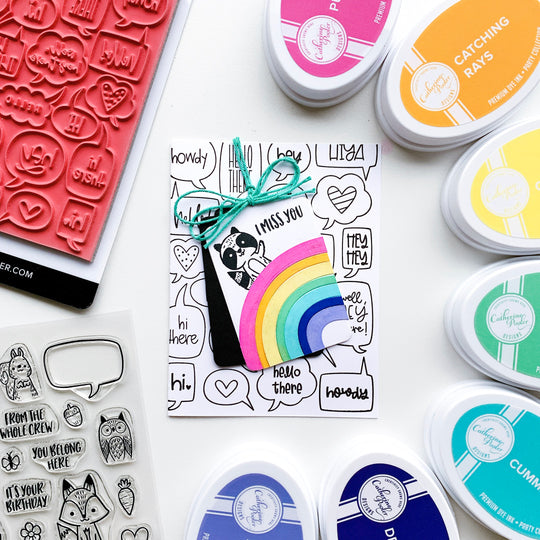 Critter Crew Raccoon with rainbow on chatterbox background
