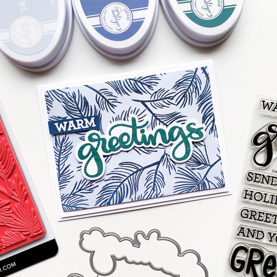 warm greetings card with pine forest background