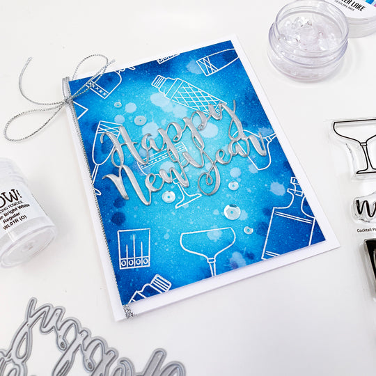 Happy New Year Word Die over Blue blended background and white cocktail glasses
