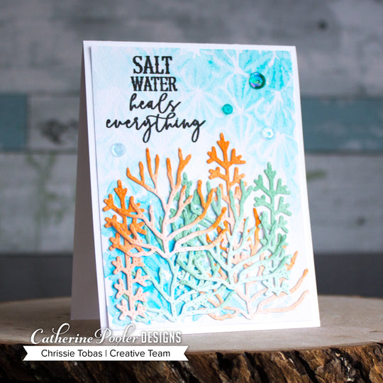 orange, blue, and green coral with sequins and salt water heals everything sentiment