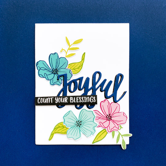 Cutout Joyful over dogwood flowers