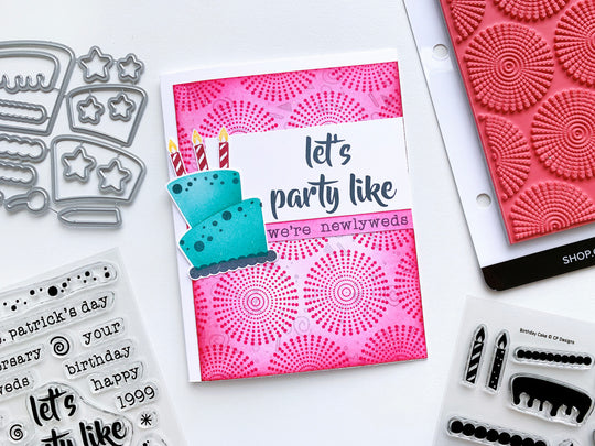 Pink blended background stamped with Dotted Bursts and a blue Remix Birthday Cake
