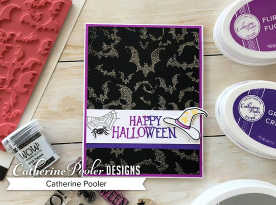 Black embossed bat background with happy halloween sentiment
