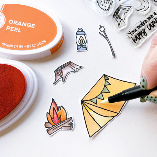 Coloring the Happy Camper stamped & die cut images with Orange Peel ink pad