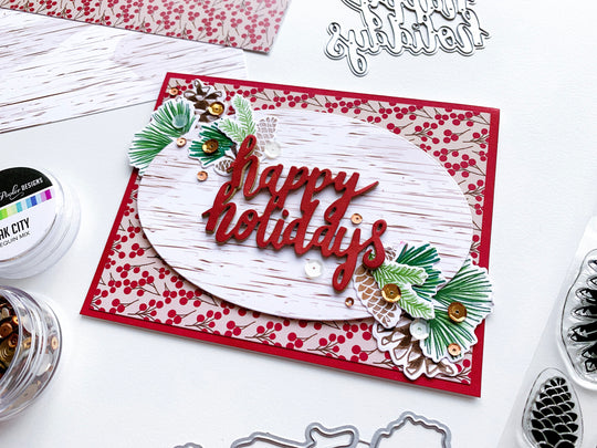 Pinecone Greetings around Happy Holidays diecut on patterned paper