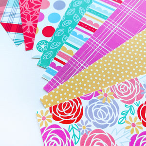 Picture of 8 patterned papers included in the Happy Mama paper pack, multi color floral, small polka dot, plaid, stripe, leaves, large polka dot, tone on tone floral and multi color plaid