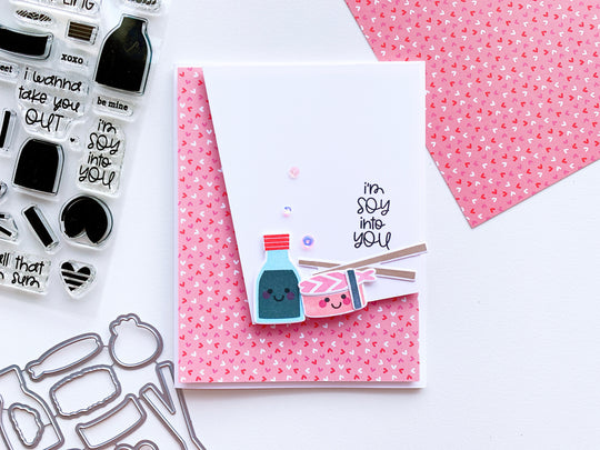 Sushi cutout pieces over pink heart paper