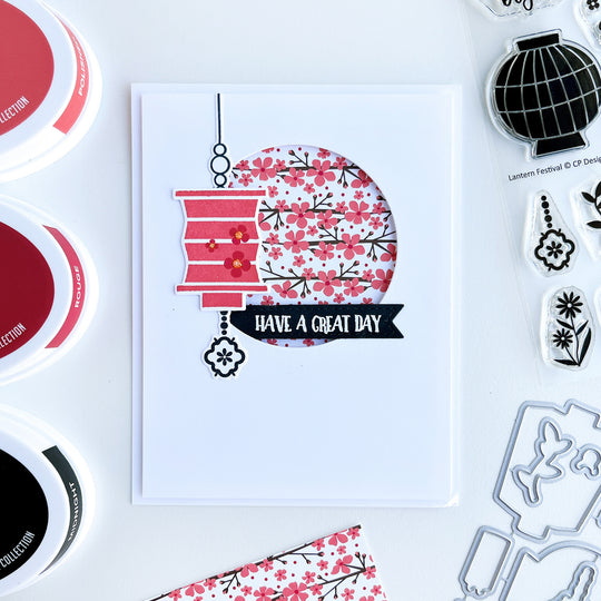 Coral lantern over circle cut our with floral patterned paper card