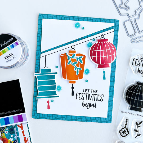 Three lanterns on a diagonal with blue patterned paper background card