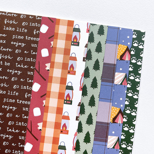 8 patterns included in S'mores Please patterned paper, phrases, marshmallows, checkerboard, lanterns, pine trees, plaid, tents, and paw prints