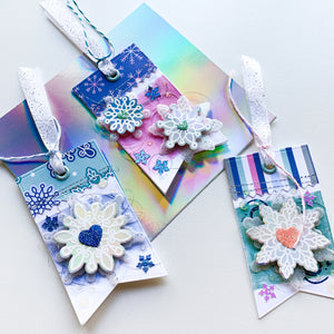 three tags made with scrolling snowflakes