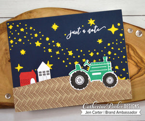 tractor and houses on navy background with yellow stars