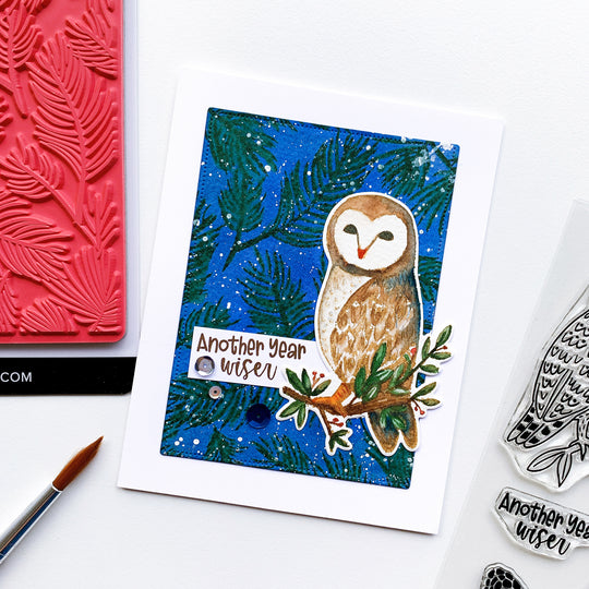 another year wiser card with pine forest background