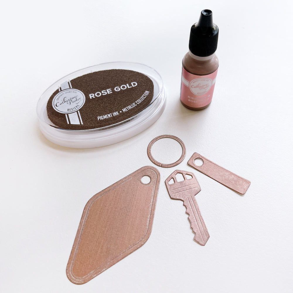 Rose Gold ink pad, ink refill bottle and paper die cut and colored with Rose Gold