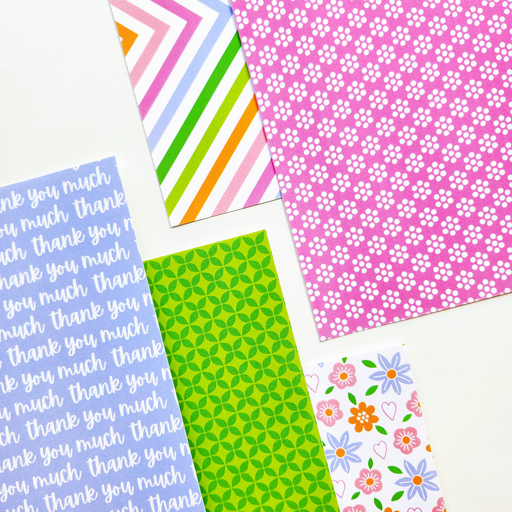 Collection of colorful patterned paper sheets on a white background