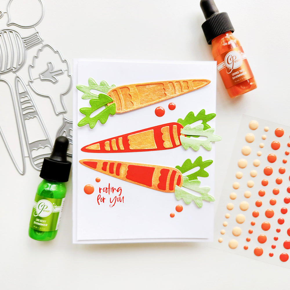 “Rooting for you” card with carrots, accented with green and orange sparkling shimmers and enamel dots. 