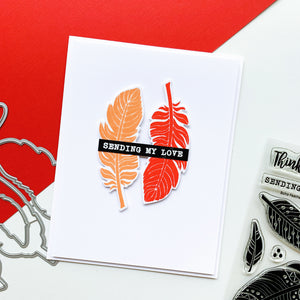 card with red and orange feathers