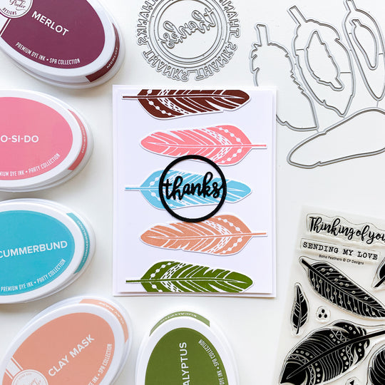Stacked feathers with round of thanks card
