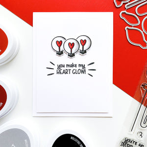 Three light bulbs with hearts card