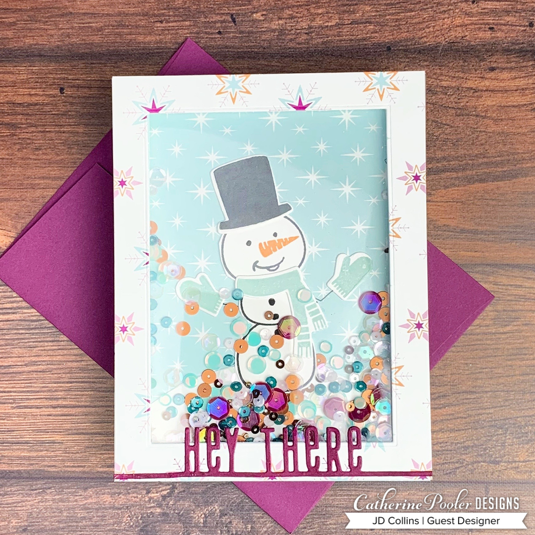 Snowman shaker card with hey there sentiment on snowflake background