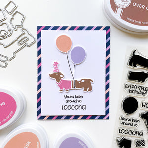 Doxie with balloons and striped patterned paper border