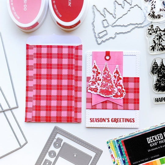 Season's greetings card with evergreen woods stamp