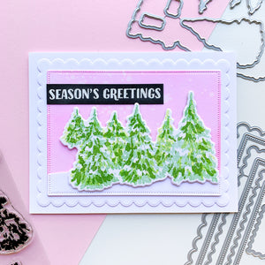 Season's greetings card with evergreen woods stamps